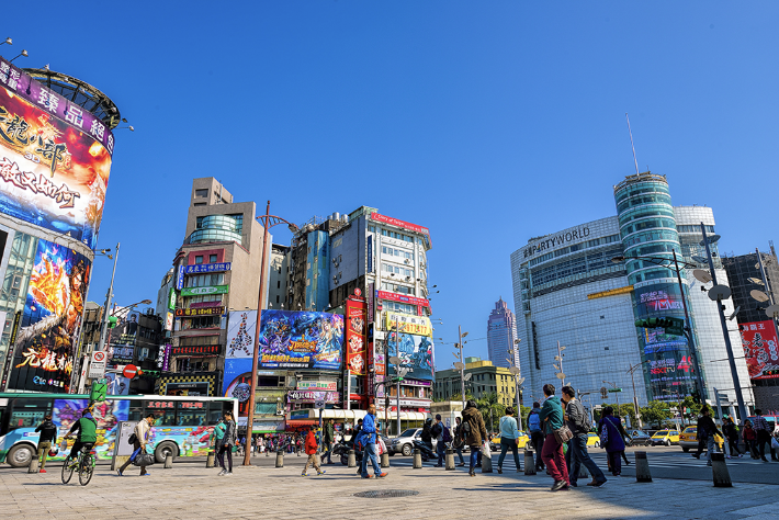 Ximending pedestrian area with bustling crowd and neon signs