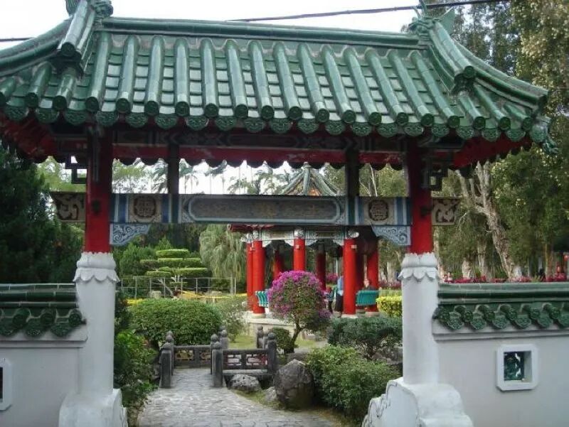 Chinese garden with arched bridge and pond