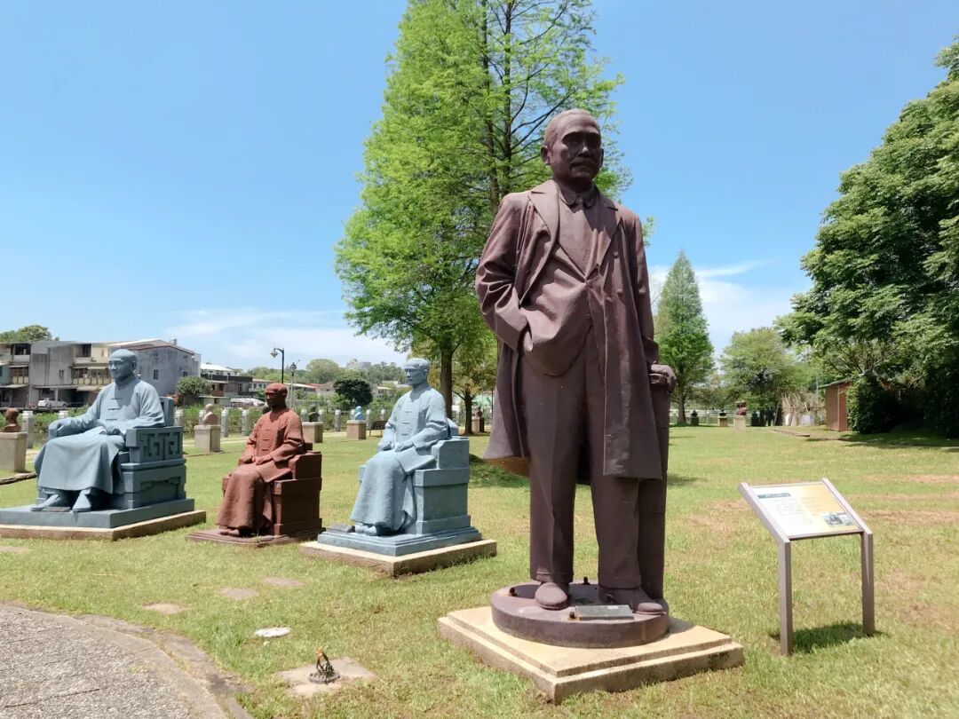 A full-length bronze statue of Chiang Kai-shek, portraying a tall and unwavering presence within the park.