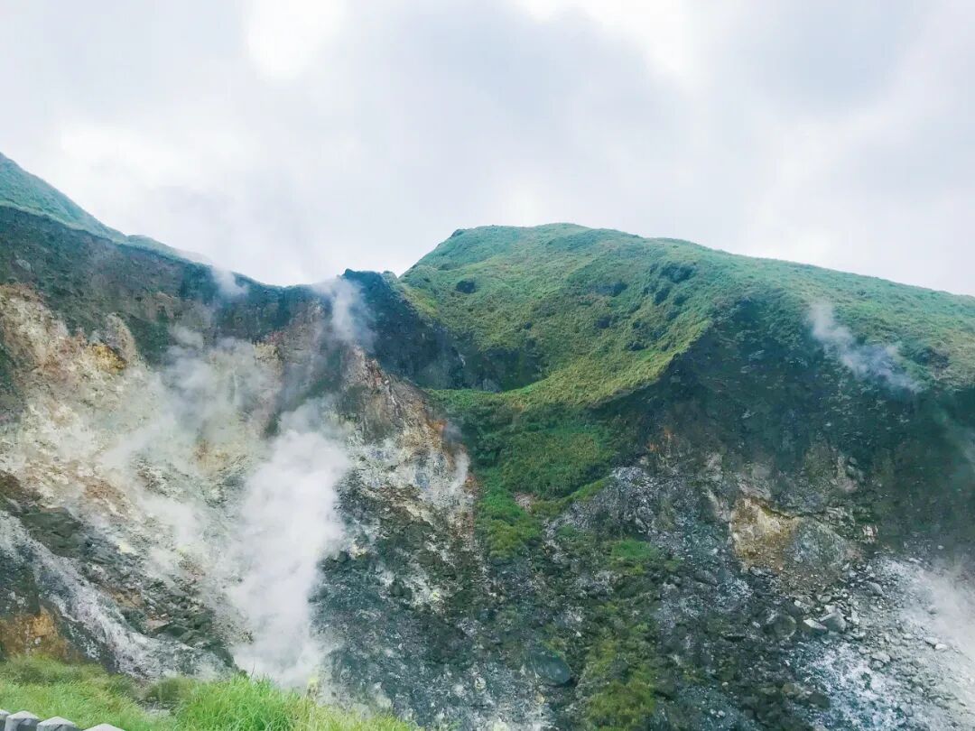 Rugged geothermal landscape of Sulfur Valley with rising steam