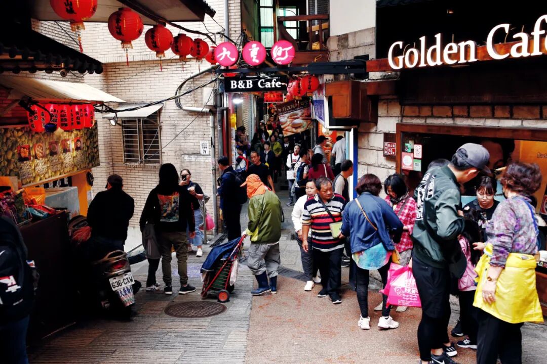 Jiufen's charming streets. Tourists exploring the unique shops in Jiufen.