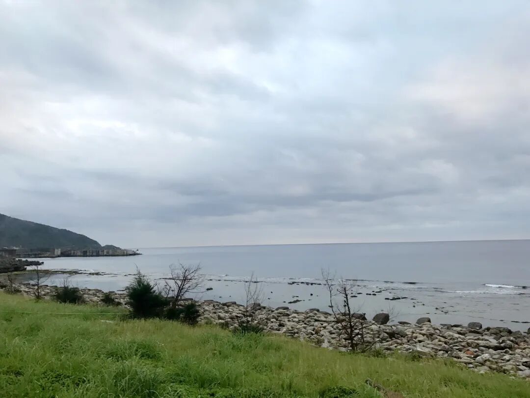 Panoramic ocean view from Green Island with dramatic cloud formations.