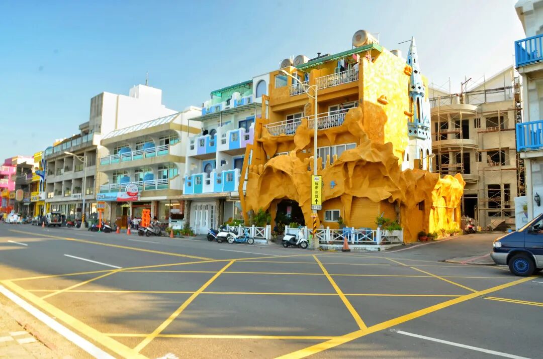 Colorful hotels and guesthouses lining Kenting Street, bustling with activity