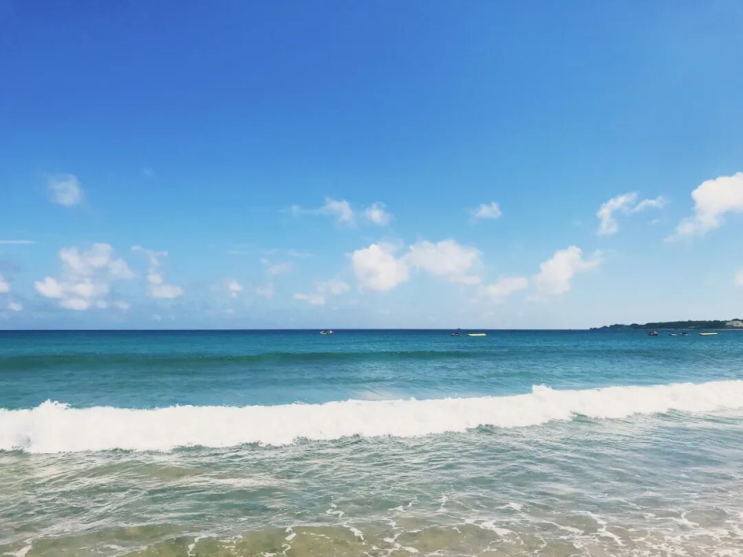People enjoying the view of the ocean, perhaps parents of the blogger