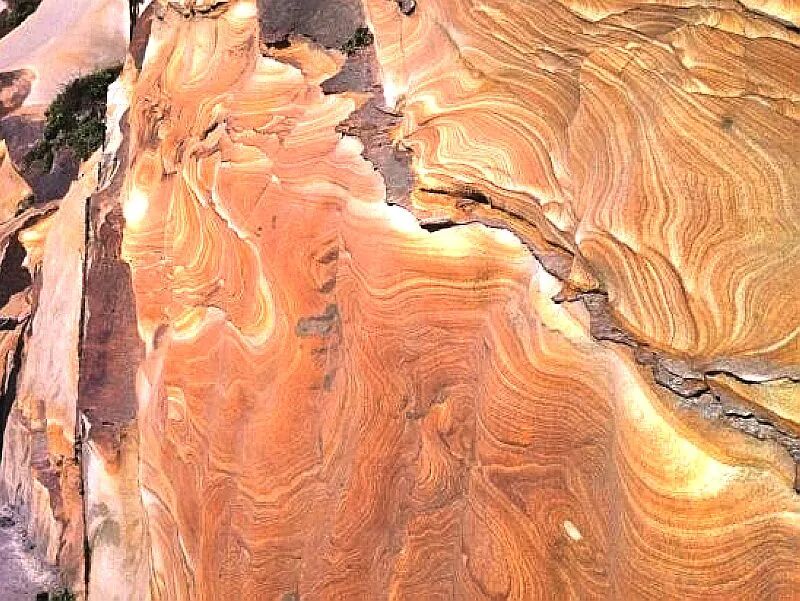 Swirling weathering patterns on rock surface