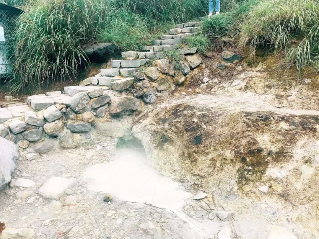 Close-up of vibrant yellow sulfur deposits and steaming vents