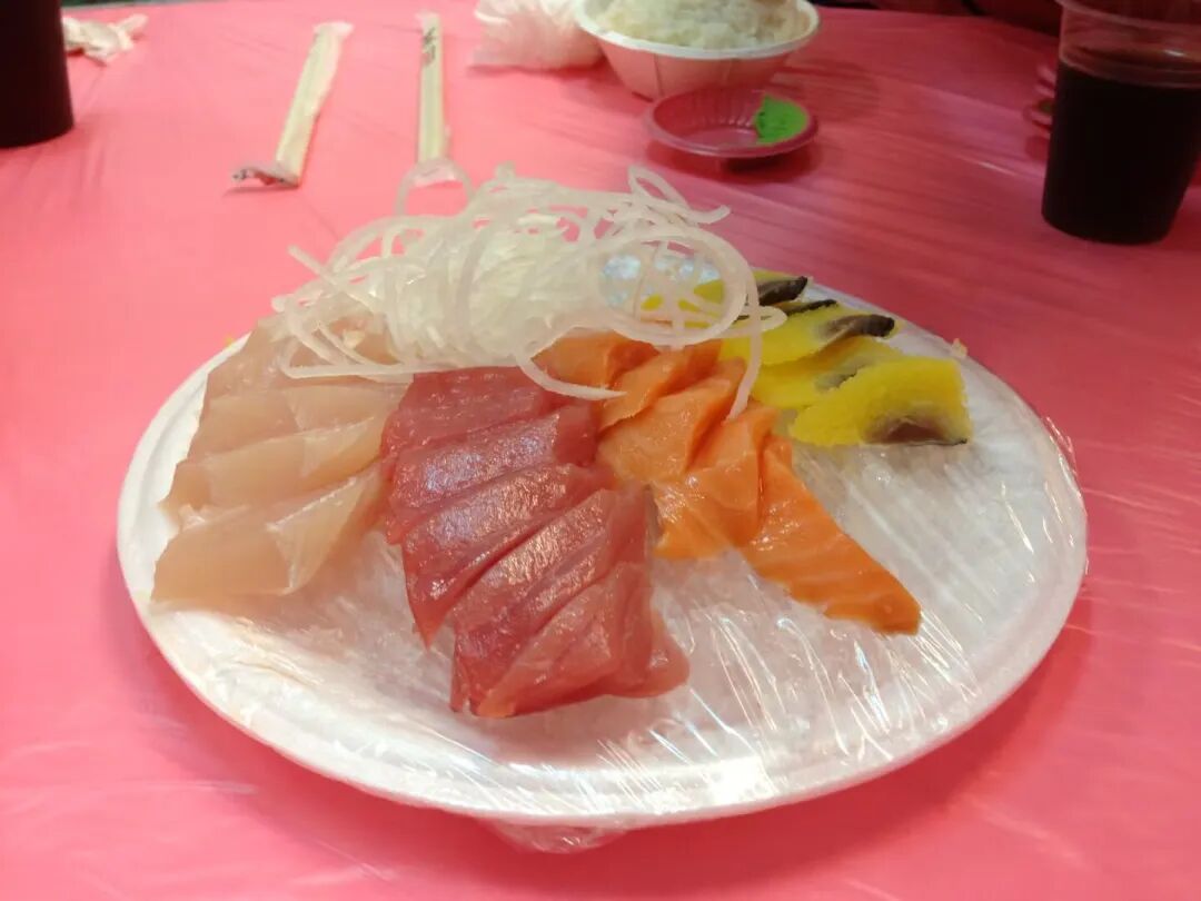 A plate of fresh sashimi, showcasing vibrant colors and delicate slices of fish