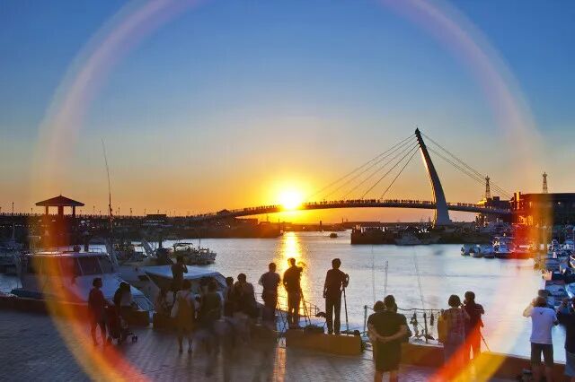 Sunset over Tamsui Fisherman's Wharf with Lover's Bridge illuminated