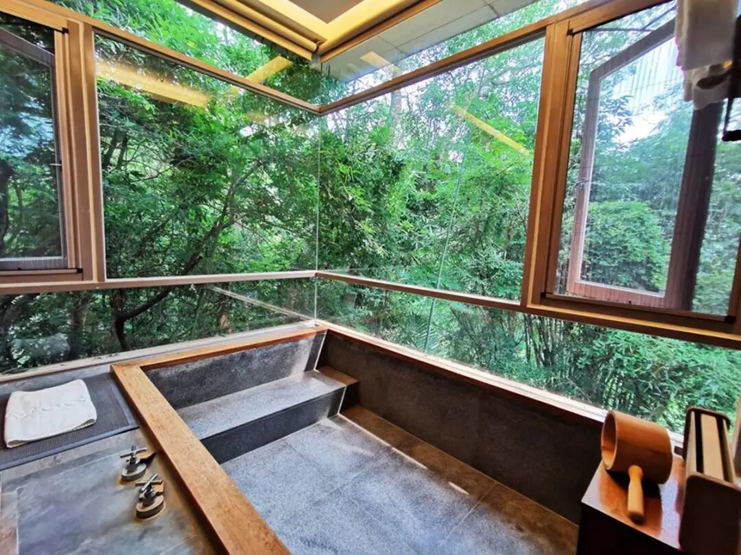Large soaking tub with floor-to-ceiling windows at Shuye VILLA