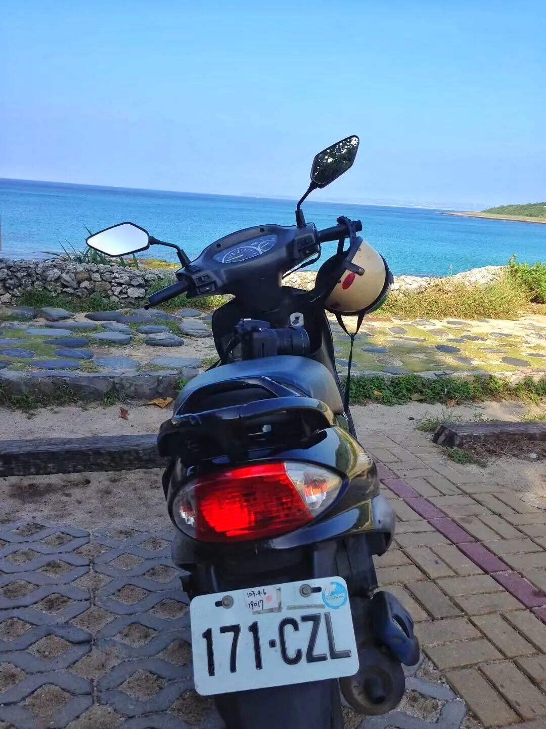 A red scooter parked on a scenic coastal road in Kenting, ready for adventure