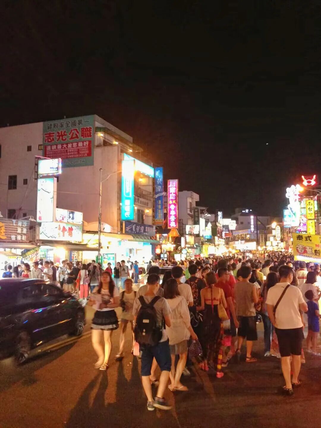 An entertainer performing for crowds at Kenting Night Market, drawing attention