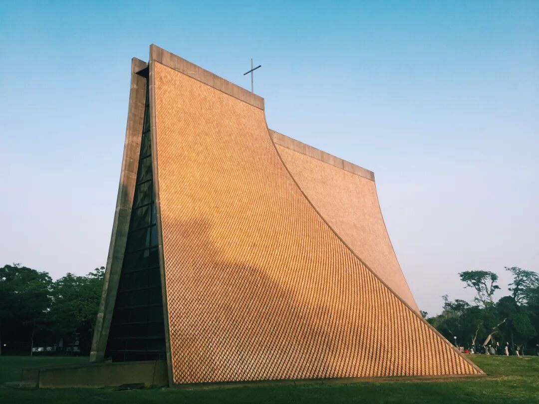 Sunset Magic at Tunghai's Luce Chapel The Luce Memorial Chapel during a stunning sunset, with hints of outdoor Christmas concert preparations.