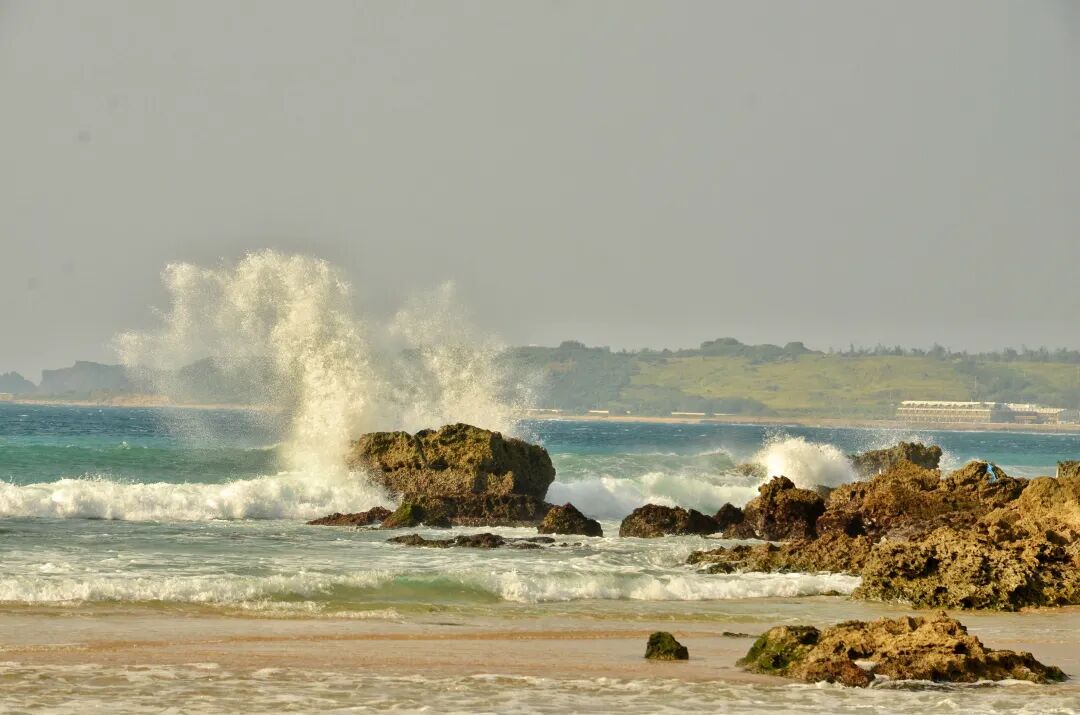 Powerful waves breaking on the shore of a small bay, ideal for surfing