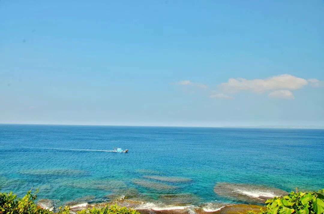 Scenic coastal view with turquoise waters and distant rock formations in Kenting