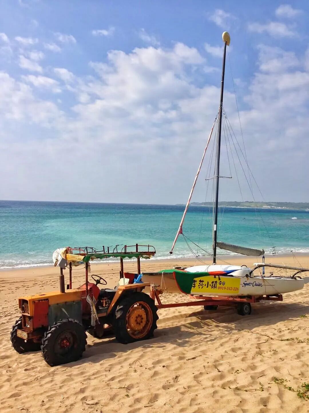 Powerful ocean waves crashing onto a rocky shore in a small bay near Kenting Street